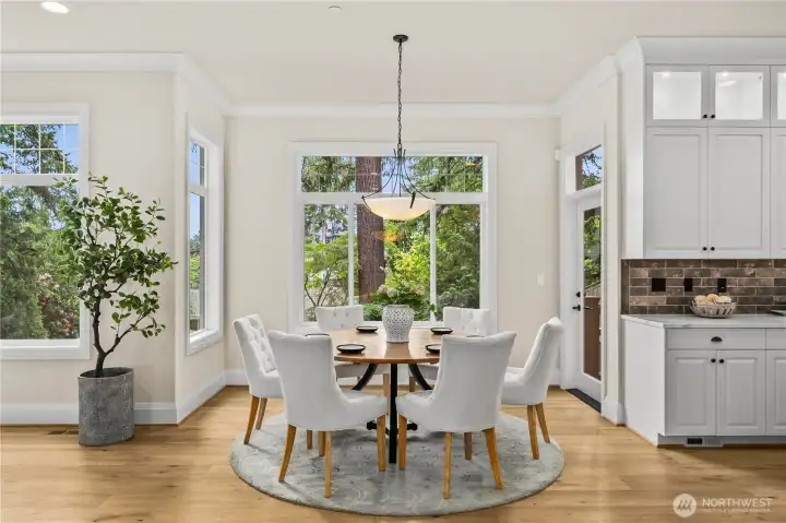 Inviting breakfast nook with serene backyard views and seamless patio access. Inviting breakfast nook with serene backyard views and seamless patio access.