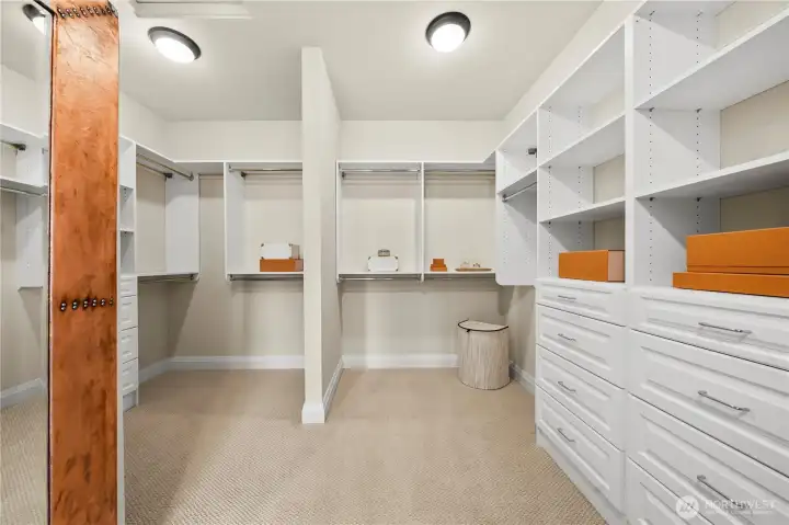 Well-appointed walk-in closet with custom organization system Well-appointed walk-in closet with custom organization system