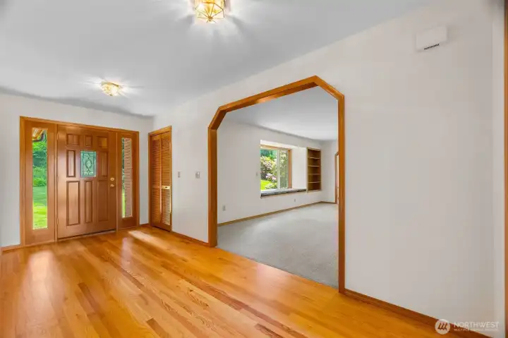 The front entry and looking into the large living room. New carpet in the home wherever there isn't hardwoods! New interior paint also. This home shines!