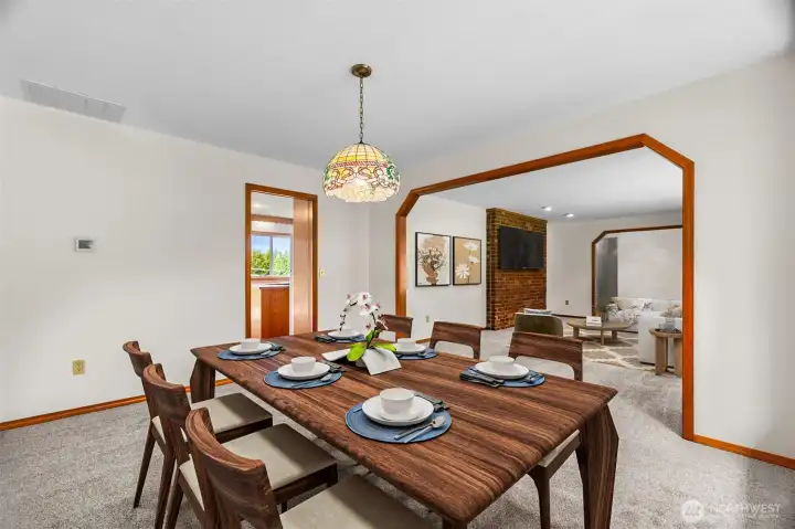 Looking from the dining area toward the living room. The kitchen and deck access is through the door on the left. (Virtually Staged).
