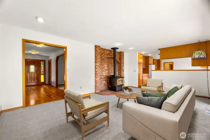 The family room, to the left is the front door entrance way. To the right is the kitchen, with the slider to the deck to the right out of the photos. (virtually staged).
