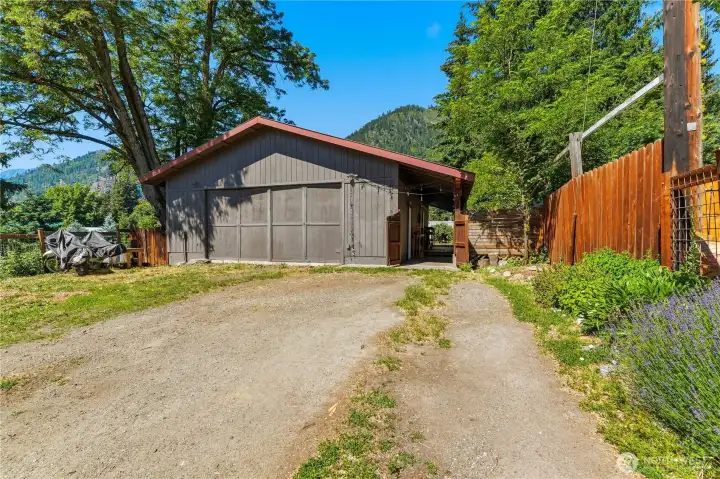Garage entrance behind the house has a gate that encloses the back yard.