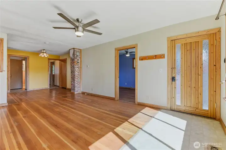 Large, sunny front room and front entrance. The primary bedroom suite is just inside the front entrance.