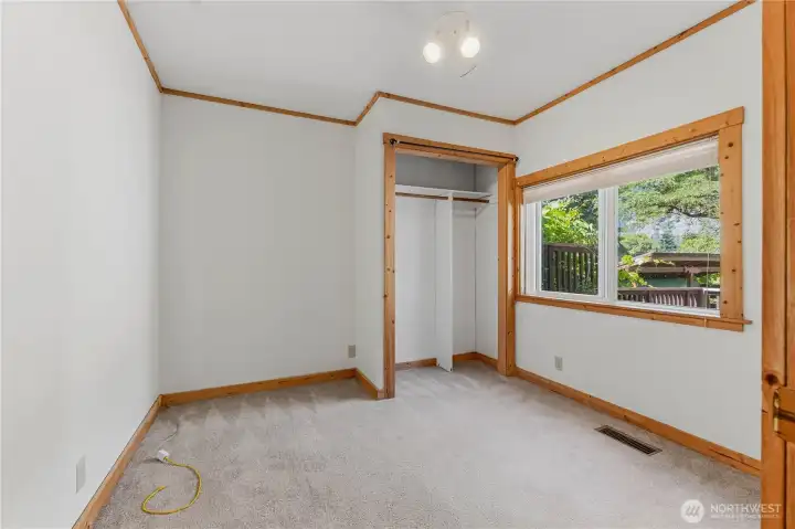 Bedroom one has wall to wall carpet & wood trim.