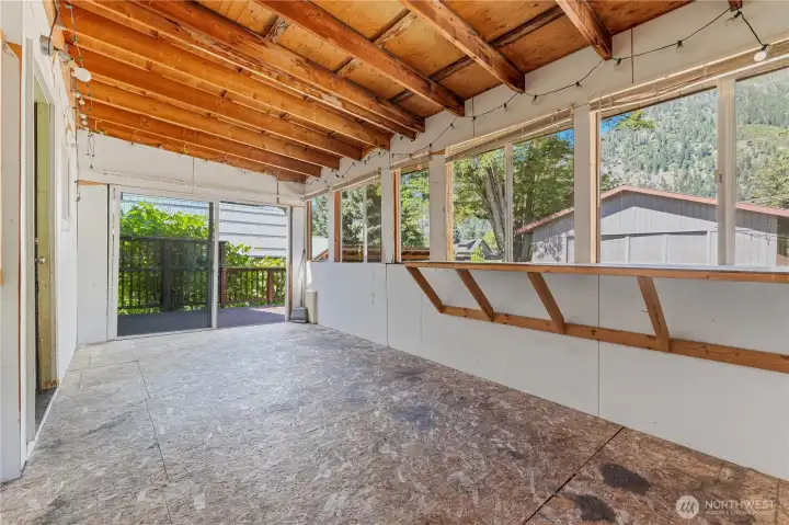 Enclosed sun room off the back of the house for storage, plants, extra living room area.