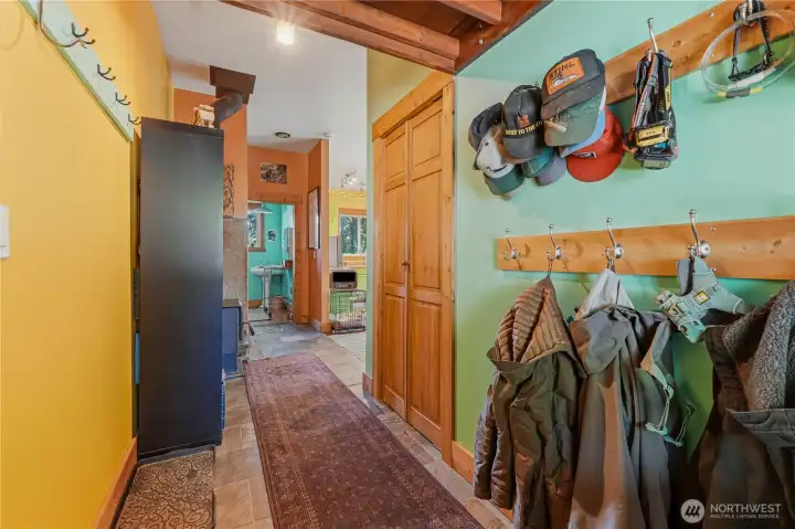 Entrance to rear flex space behind the garage has lots of hooks & storage above the door.
