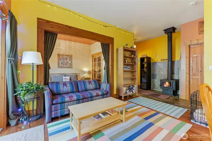 Rec room in rear flexible space has a wood stove & french doors to the back deck & yard.