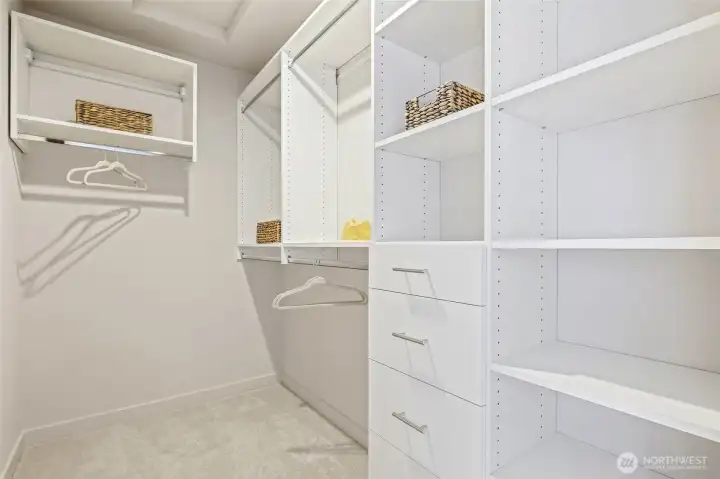 Photos of model home 9752 with similar finishes & floor plan. Organized living made simple with this generous walk-in closet—custom shelving means there's a place for everything.