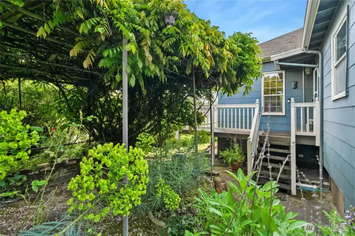 The layout positions the kitchen with convenient proximity to the back patio and yard, making outdoor grilling, al fresco dining, and garden highly accessible