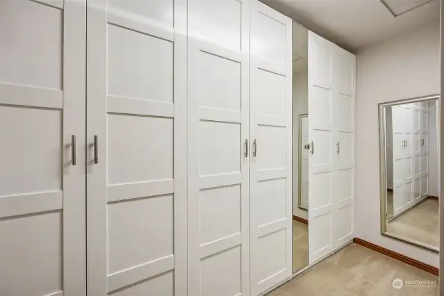 Your dream walk in closet has gorgeous built-ins with mirror accent to organize your entire wardrobe just off of the primary suite bathroom.