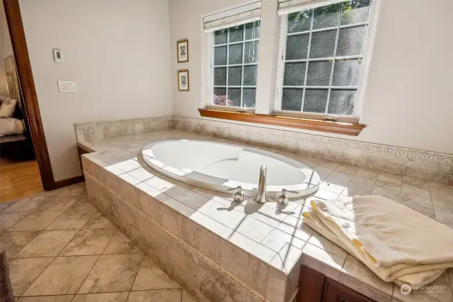 Take a sun dappled deep soak in the tiled in tub of the primary suite thanks to the twin paned windows. Water is provided by a 350’ deep well located right behind the RV garage with a 2,000 gallon underground holding tank that fills at 3-4 gallons per minute!
