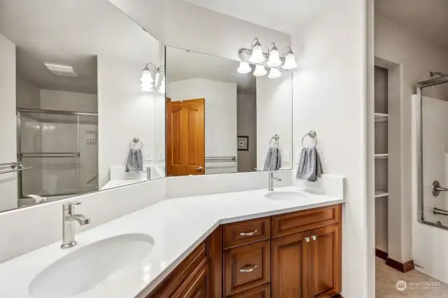 One of THREE upstairs bathrooms, this one serves the first two bedrooms and has space for everyone to get ready in the morning thanks to the extra long vanity with two sinks, plus extra storage in the linen closet and vanity drawers.