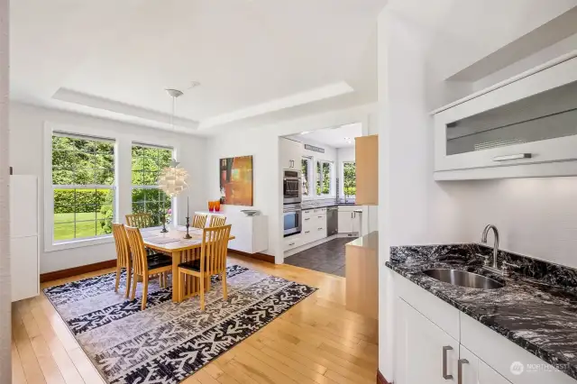 A pretty tray ceiling tops this spacious dining room, with built-in butler bar with undermount sink ready for your dream coffee, tea or cocktail station!