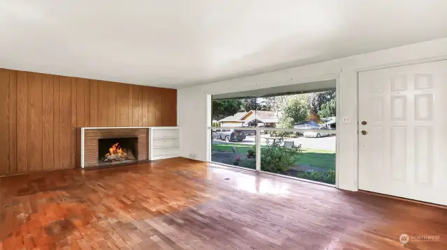 Nice picture windows let in plenty of light. A wood burning fireplace for the upcoming winter months. Six panel white front door, nice built-ins.