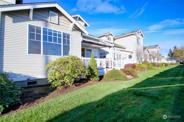 Back of home with covered deck.