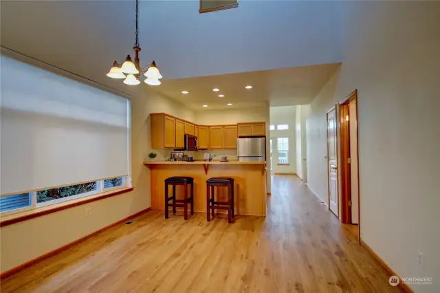 Looking towards kitchen and eating bar from entry