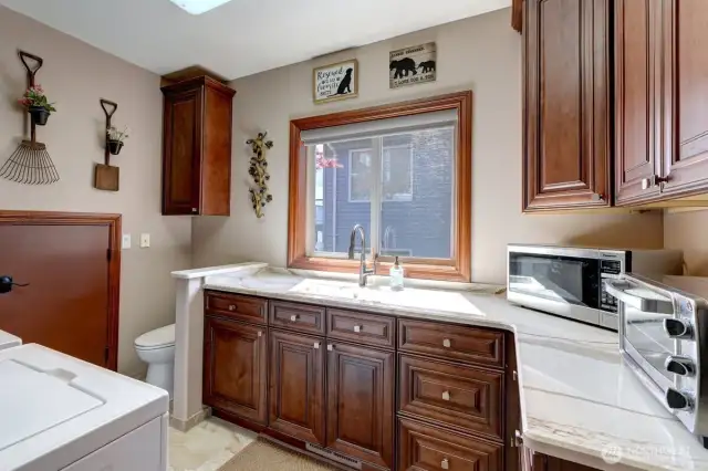 Laundry room off kitchen offers a spacious & convenient work space.