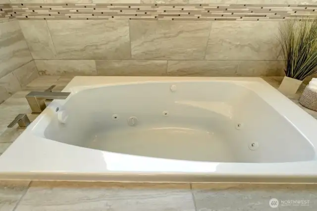 Luxurious jetted tub in primary bath.