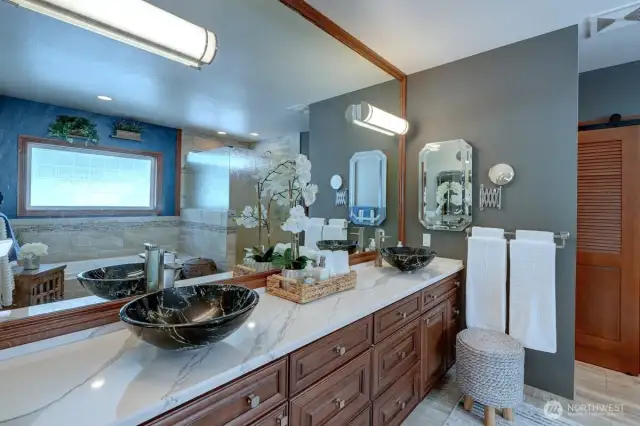Double raised bowl sinks highlight the beautiful primary bath.