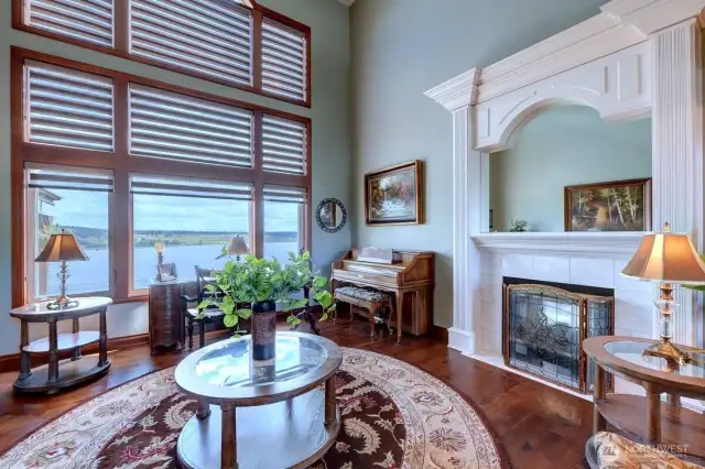 Formal living room offers two sided fireplace which also serves family room.