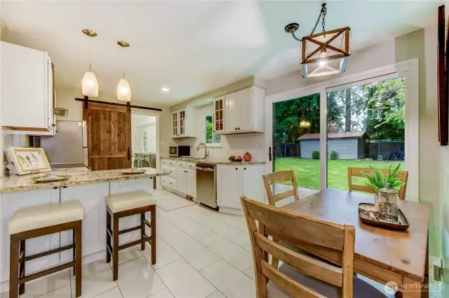 Recently updated kitchen and dining space. Slider leads to the large backyard.