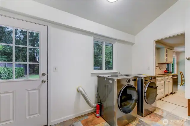 Utility room with washer & dryer. Conveniently placed door leads to the back yard.