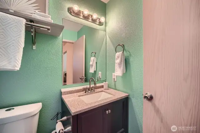 This well-appointed half bath offers essential convenience with a sleek sink and modern toilet—perfectly designed for guests or quick use.