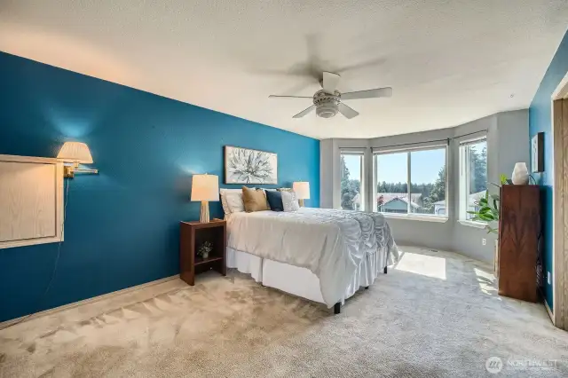 Primary Bedroom with Charming Bay Window  The spacious primary bedroom features a beautiful bay window that floods the room with natural light and creates the perfect spot for a cozy reading nook or quiet reflection.
