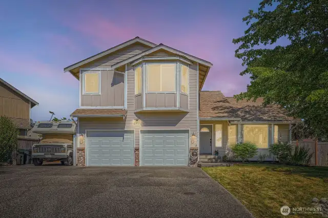 Stunning Twilight Curb Appeal  Experience your home’s enchanting charm as it glows softly at twilight, welcoming you with warm, inviting light and captivating presence.
