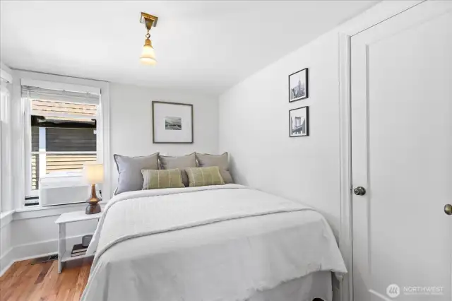 Bright and fresh bedroom with closet, hardwood floors and natural light.