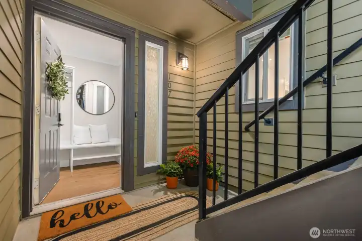 A private ground-floor entry greets you with fresh exterior updates, potted flowers, and just 5 easy steps from street to door.