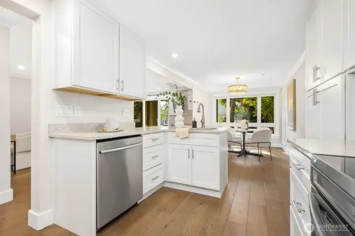 Quartz counters, updated cabinetry, and stainless steel appliances bring modern style and functionality to this beautiful kitchen.