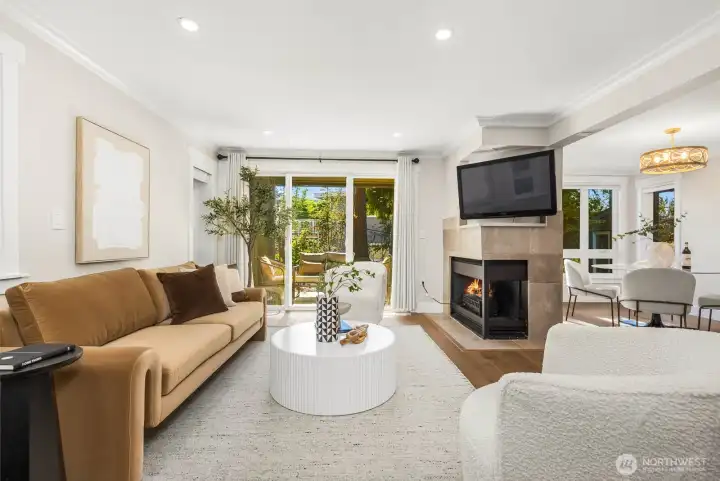 Centrally placed fireplace creates a stylish focal point between dining and living spaces.