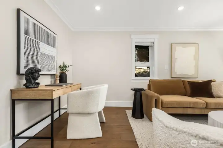 Another view of the living area showcasing fresh paint, new floors, and a flexible layout.