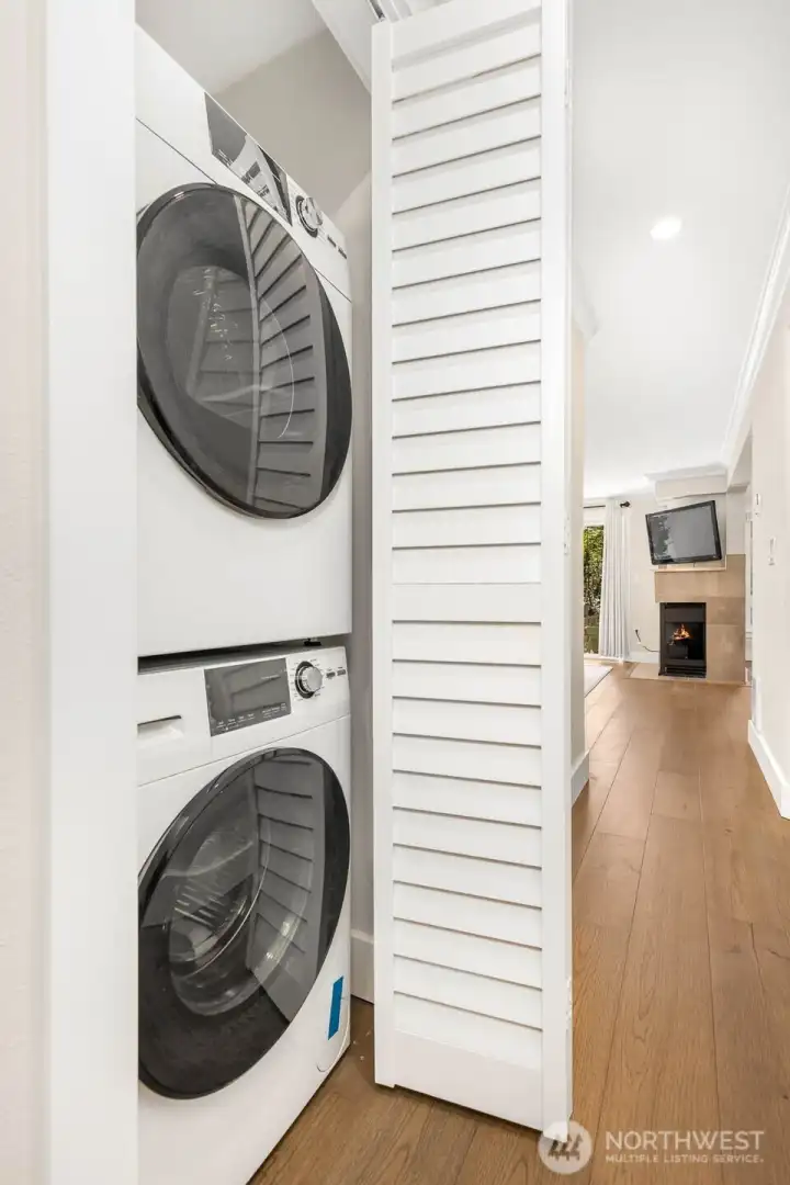 Convenient in-unit laundry with a full-size, stackable washer and dryer tucked neatly behind doors for easy access.