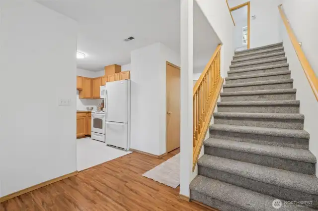 The stairs lead to a large primary suite and two additional bedrooms.