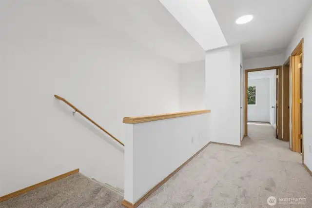 The carpets are brand new and the walls are freshly painted. There is a skylight located above the stairs.