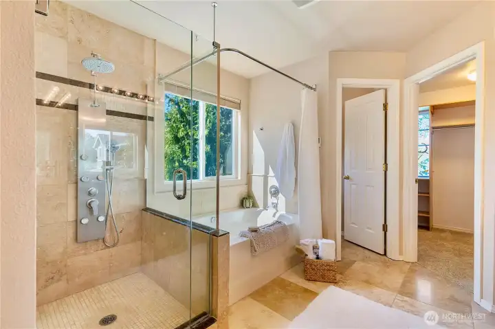 Relaxing En-suite bathroom with multi-head shower, radiant heated flooring and deep soaking tub