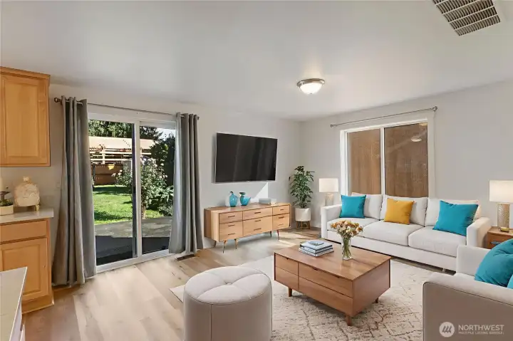 Spacious family room virtually staged off kitchen with sliding doors to expansive patio.