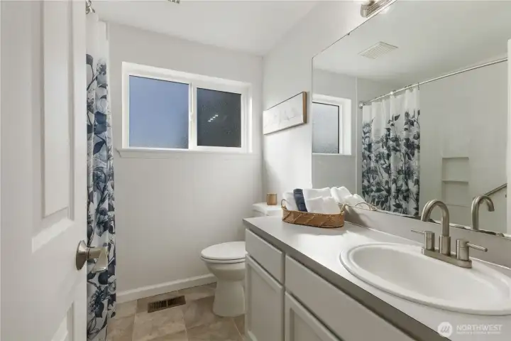 Main bath with spacious vanity.
