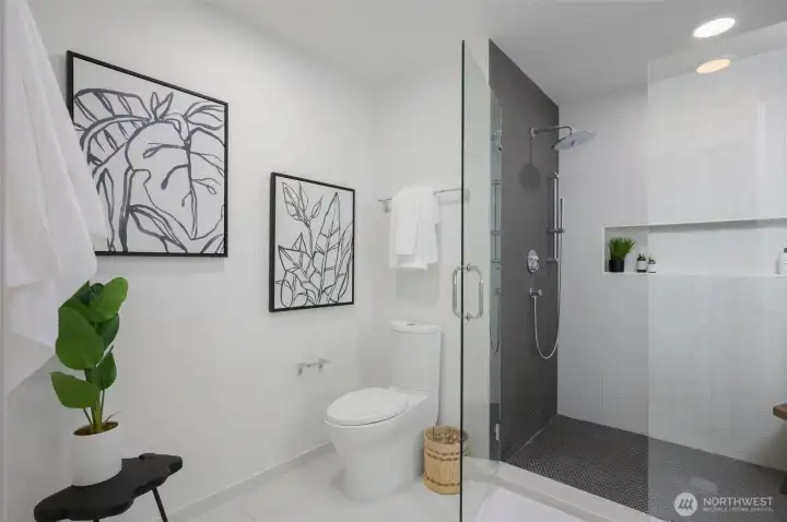 Bathroom features a ceramic tile walk-in shower and a floating quartz vanity with a daylight mirror.