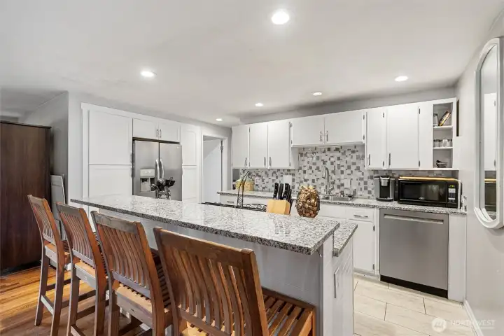 Breakfast Bar -   Oversized breakfast bar with granite counters, abundant seating, and a great open connection to the updated kitchen.
