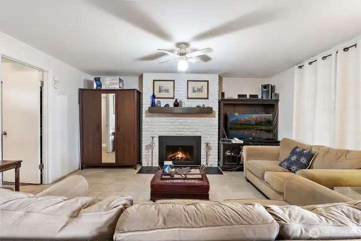 Living Room with Gas Fireplace - Comfortable living room with painted brick fireplace hearth.  A truly warm and inviting space to relax or host guests.