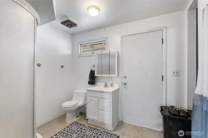 3/4 Bathroom -   Additional 3/4 bath with conveniently located corner shower unit, updated vanity and practical utility-room plus access to the back yard patio area.