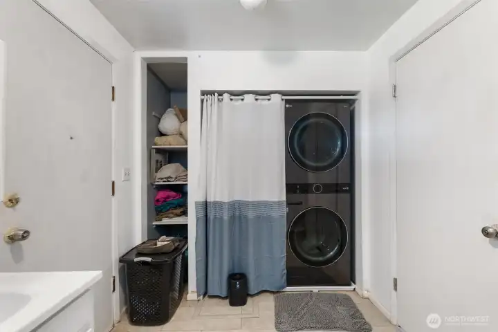Utility/Laundry Room - Large utility/laundry room featuring updated LG full-size stacked washer and dryer, extra storage, and added everyday convenience.