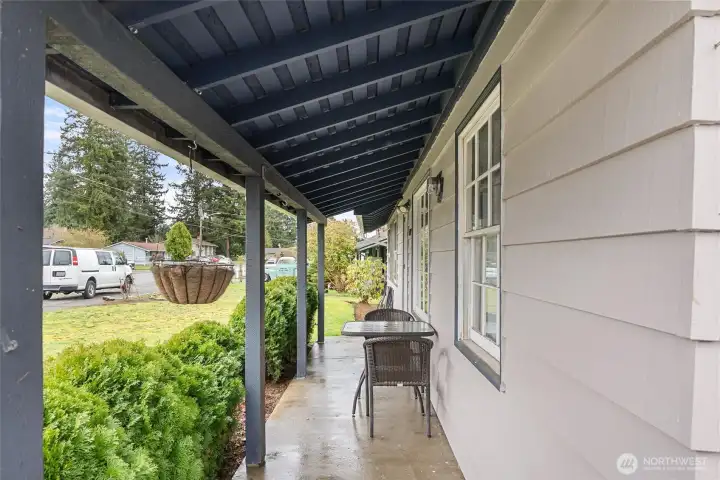 Covered front porch offers a comfortable spot to relax and enjoy the neighborhood setting year-round.