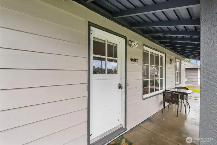 Covered front entry welcomes you home with charm, protection from the elements, and classic curb appeal.