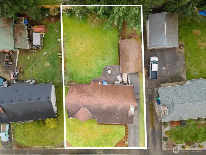 Lot (Aerial)  Outlined aerial lot view clearly shows the property footprint, spacious backyard, detached garage, and long driveway parking.