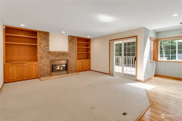 Another view of the great room shows the nice built in shelving situated next to the gas fireplace.  Another access onto the deck is great for entertaining
