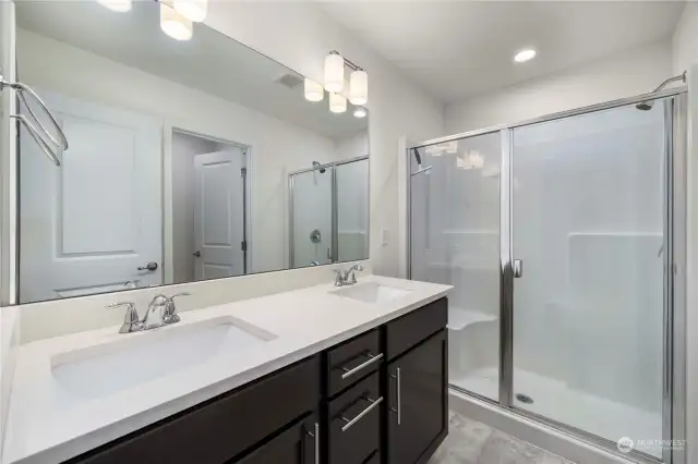 Double vanities in primary bath, along with a large walk-in shower.